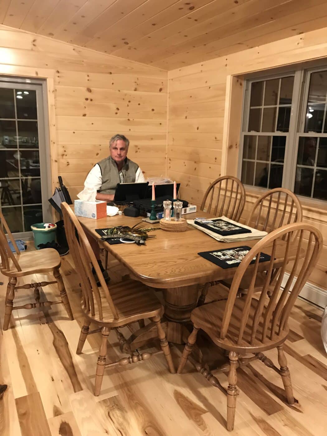 a man enjoying his new dining room inside his gorgeous prefab log cabin in parson west virginia