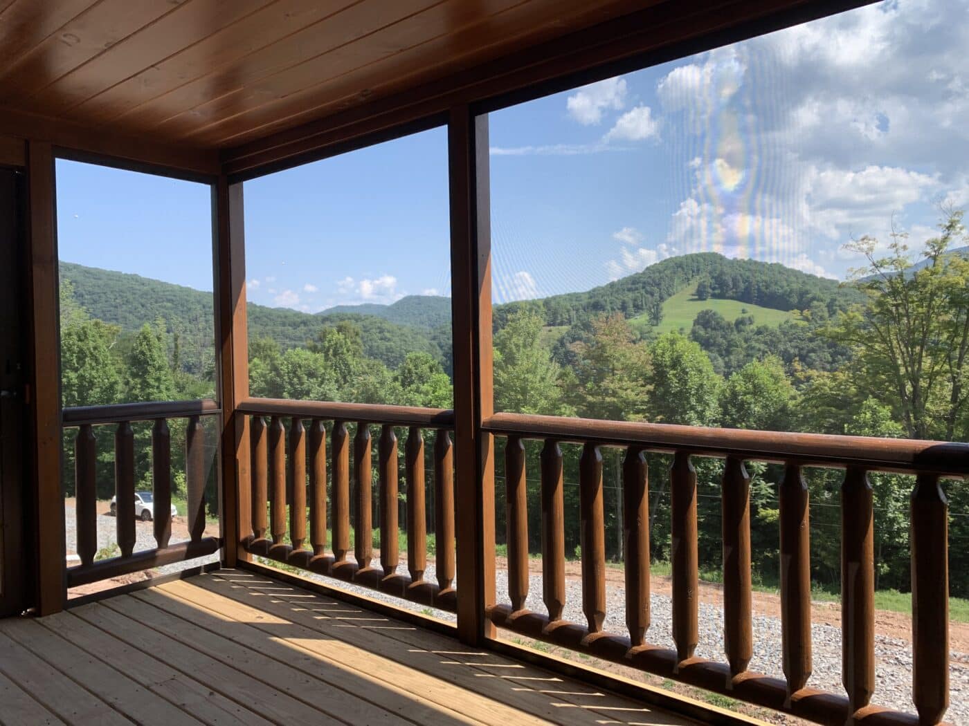 jaw dropping view from the deck of a prefab log cabin overlooking the green moutains of parson west virginia