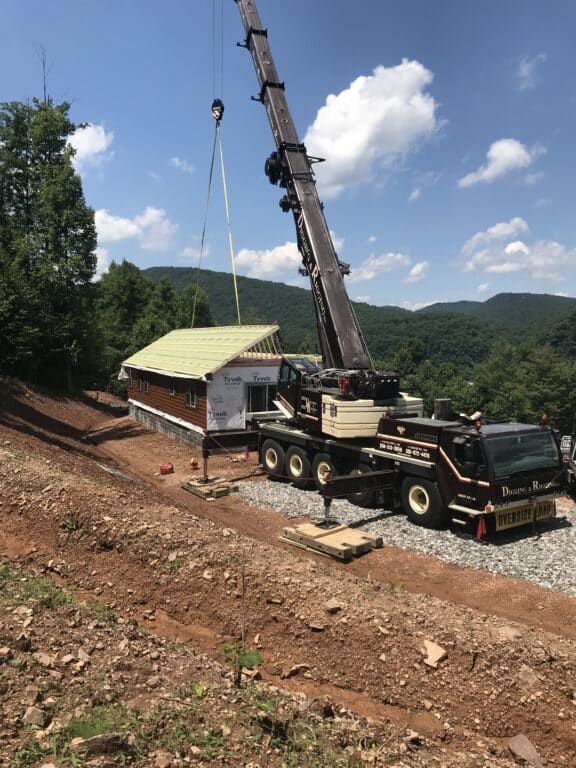 placing the new prefab log cabin together in parson west virginia