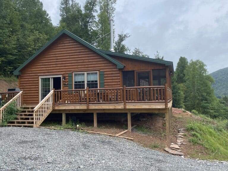 stunning brand new prefab log cabin in the spring in parson west virginia with green foilage all around
