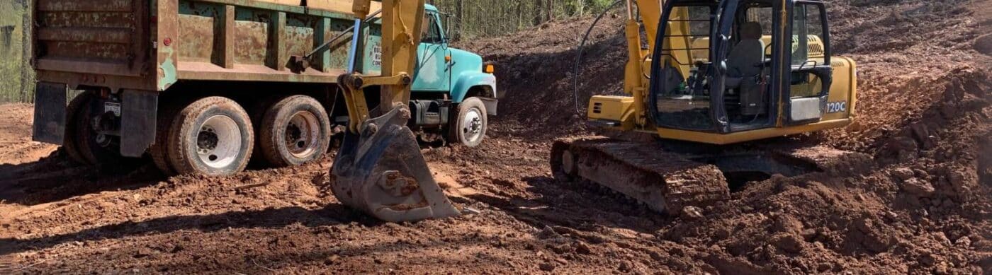 Site preparation on dirt foundation with construction vehicles