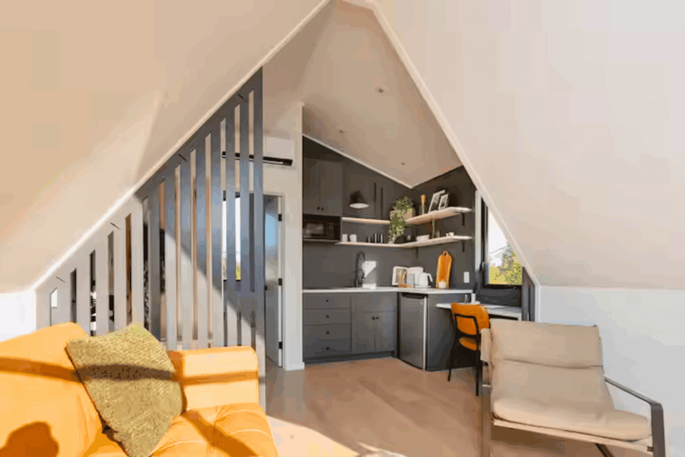 A frame park model tiny home living room and kitchen area built and designed by Zook Cabins in Gap Pa unit located in Durango Co