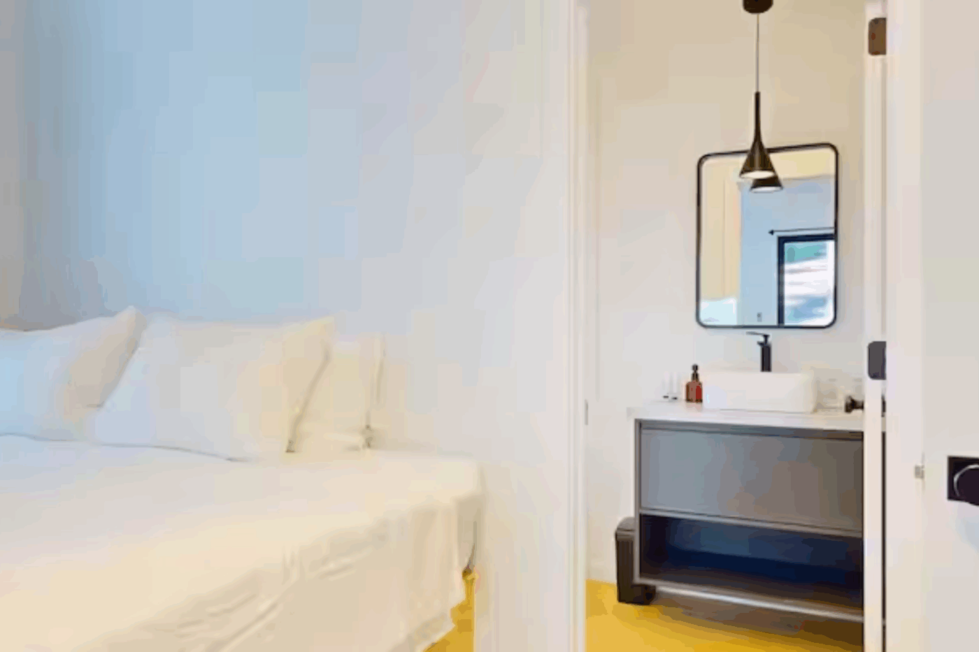 Cozy bedroom with private bathroom in A frame park model tiny home built and designed by Zook Cabins in Wiscasset Maine