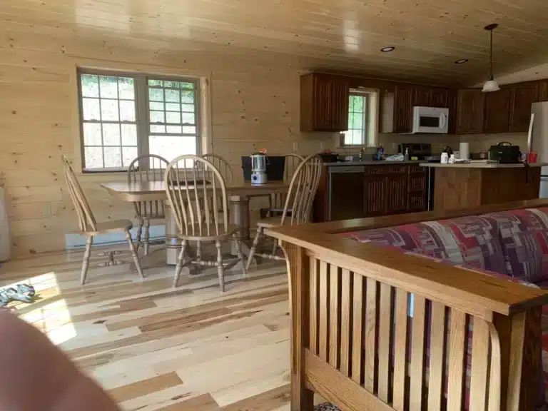 Family shaking hands with a lender over financing a log cabin