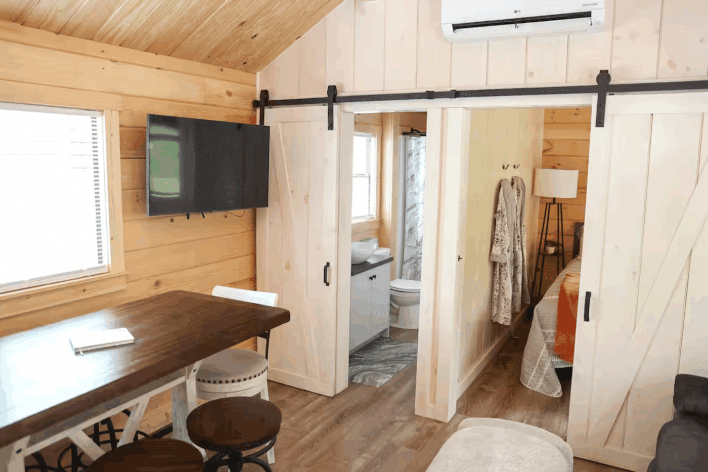 Pinecrest park model tiny home in Spring Mill Pa with large living and dining are built and designed by Zook Cabins featuring second bedroom and large bathroom