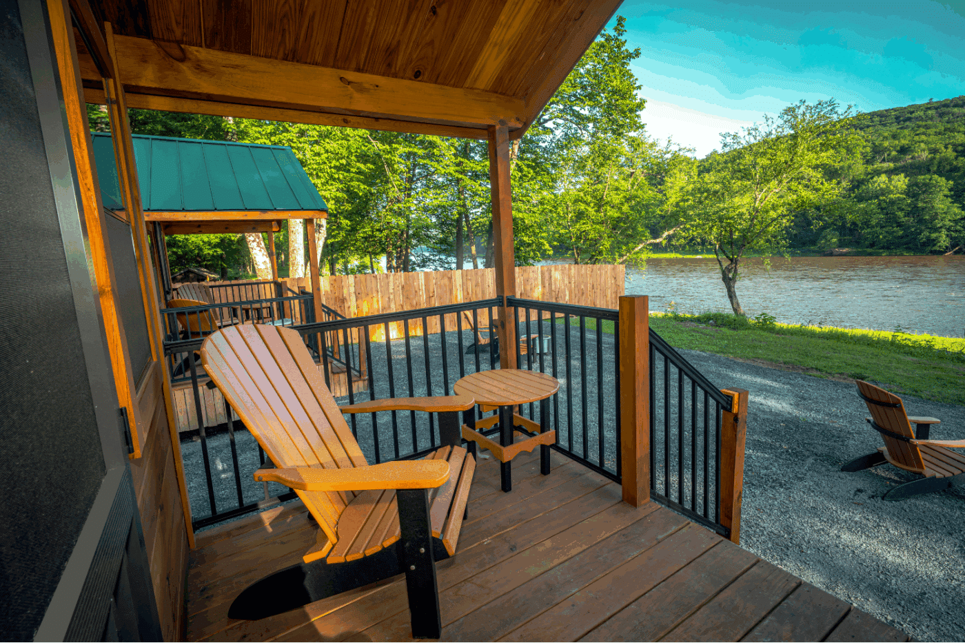 front porch of log studio park model tiny home in Pond Eddy New York at The Outpost cabin 1