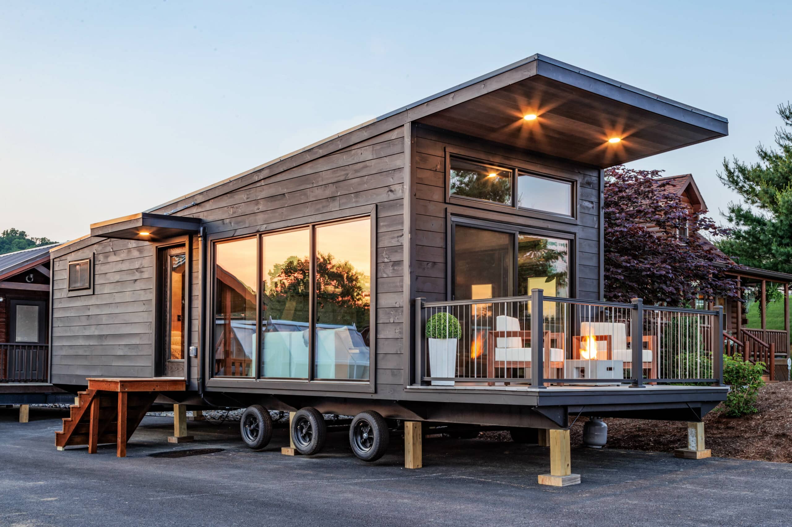 Tiny home on wheels with a balcony during sunset