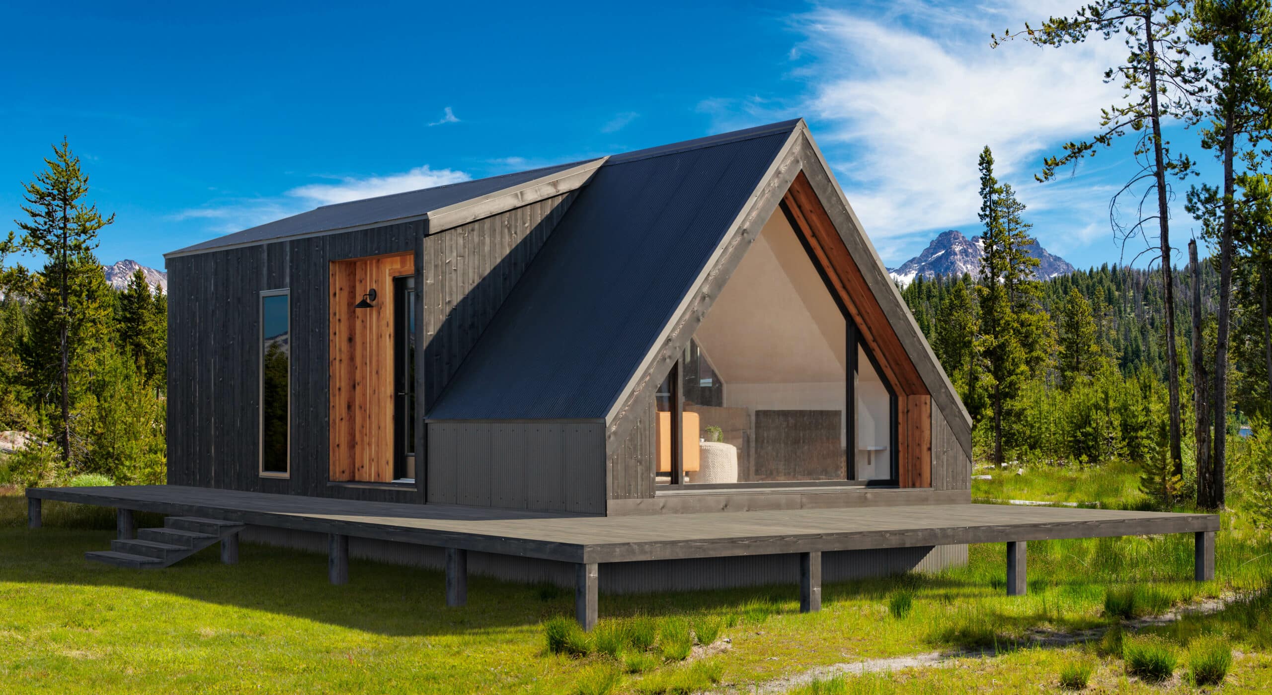 A modern style cabin in a clearing in the woods on a sunny day