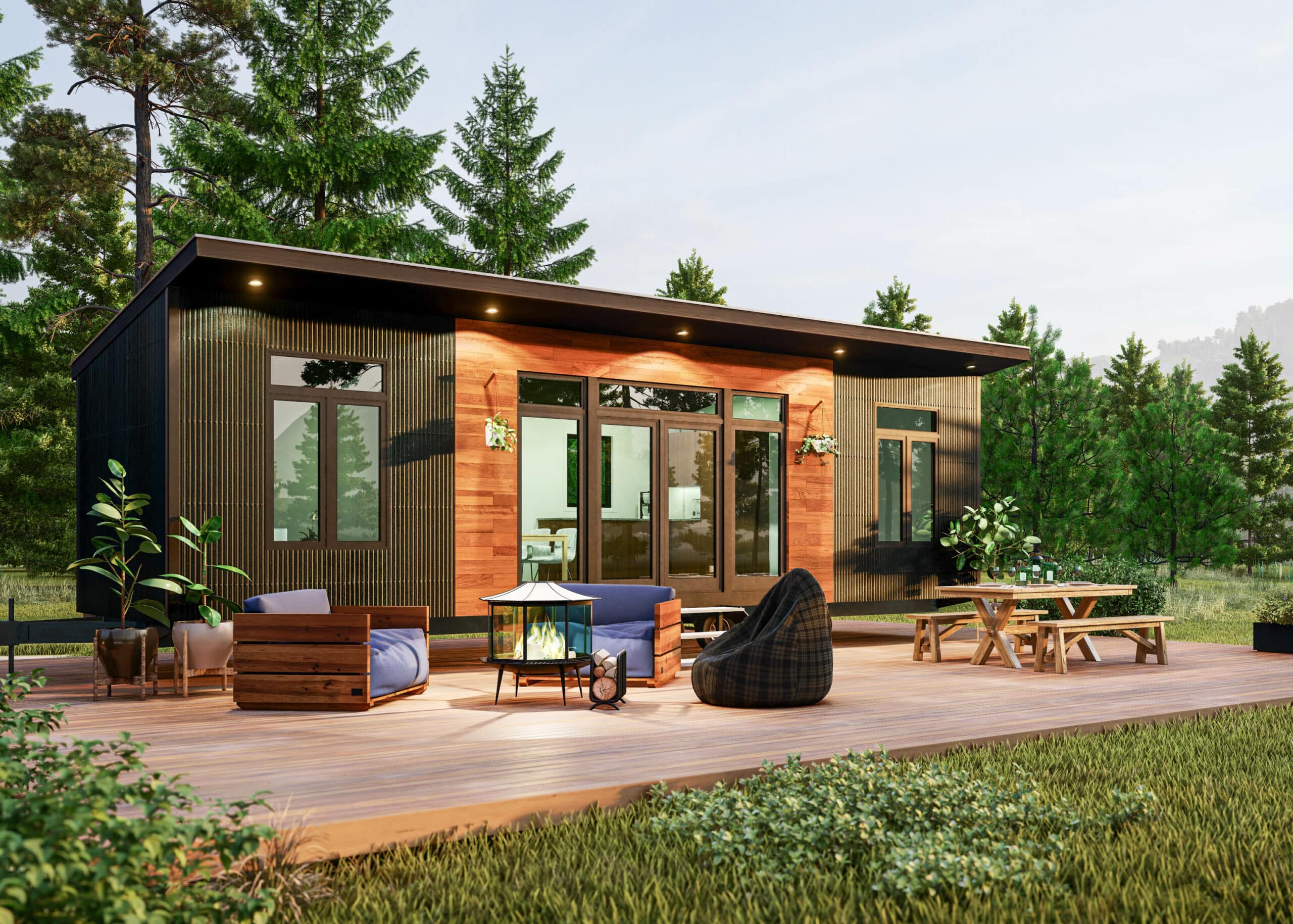 A modern tiny home with seats and tables outside in the evening