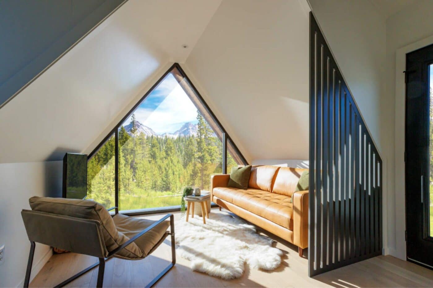 Inside living area of A-Frame Tennessee Tiny Home with view of forest and mountain