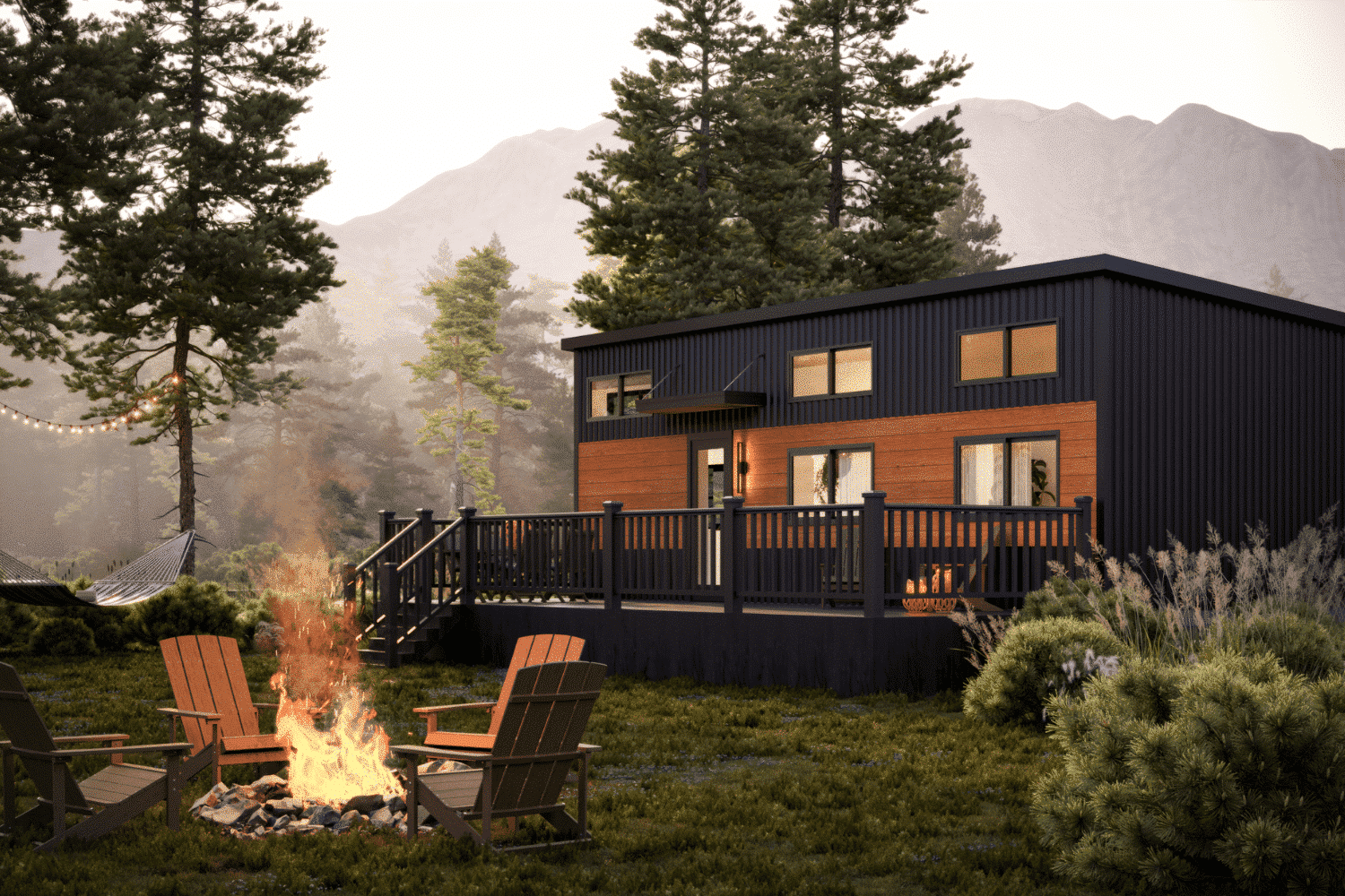 Modern tiny home with a spacious deck, set against a backdrop of tall pine trees and mountains. The outdoor area features Adirondack chairs around a fire pit, a hammock, and string lights creating a cozy ambiance.