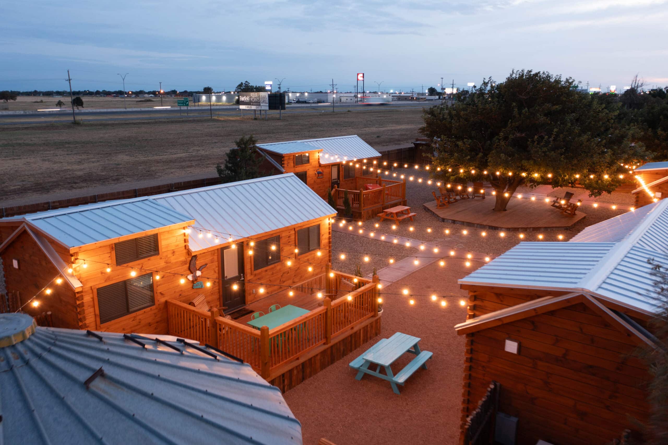 tiny home community in michigan in the evening with string lights