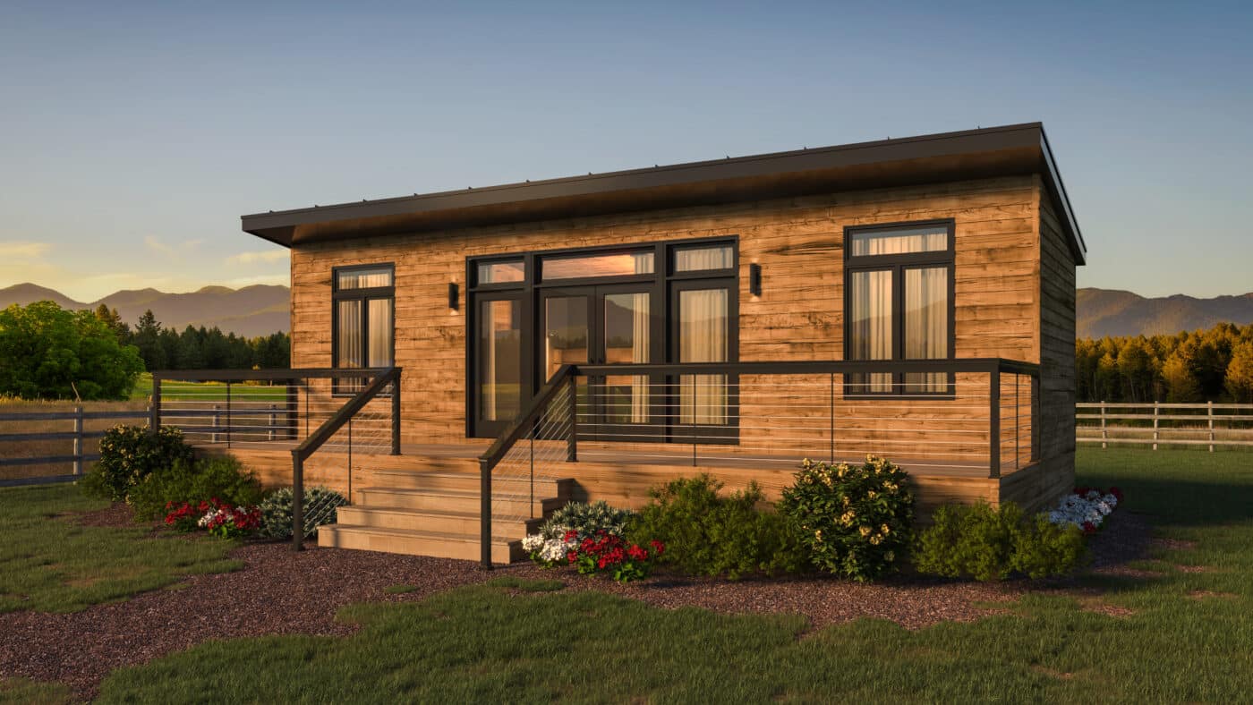 wooden park model home on wooden foundation with steps leading up to two clear front doors