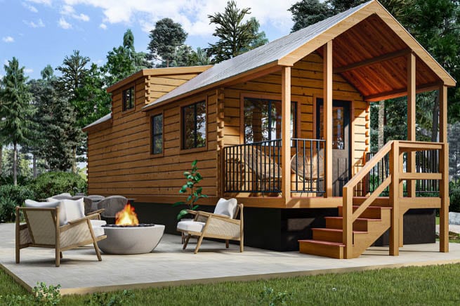 The aspen, tiny home with a porch, a staircase, and seats outside on a sunny day in South Carolina