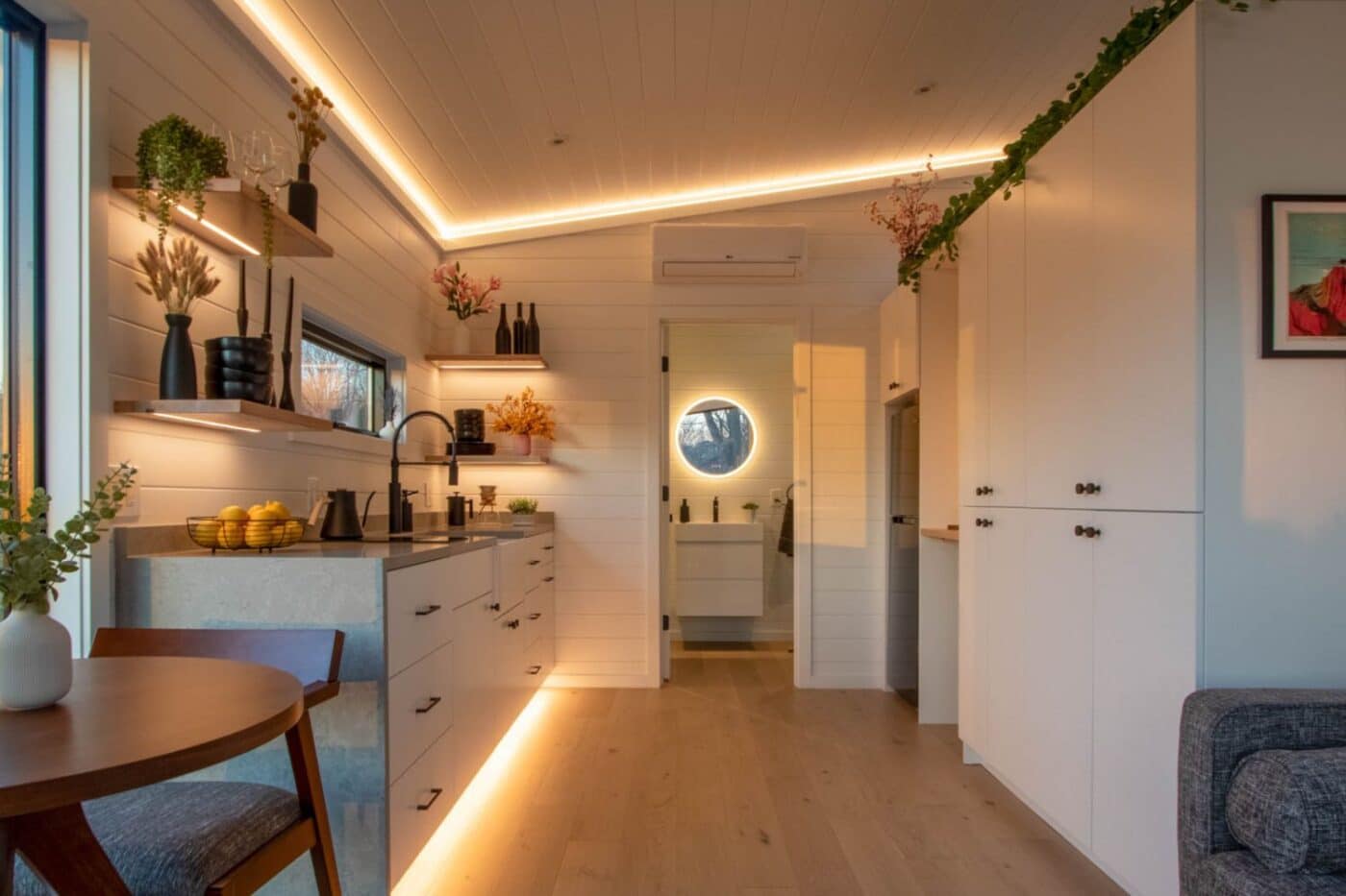 Inside of Alpine tiny home with view of kitchen table, kitchen, and bathroom