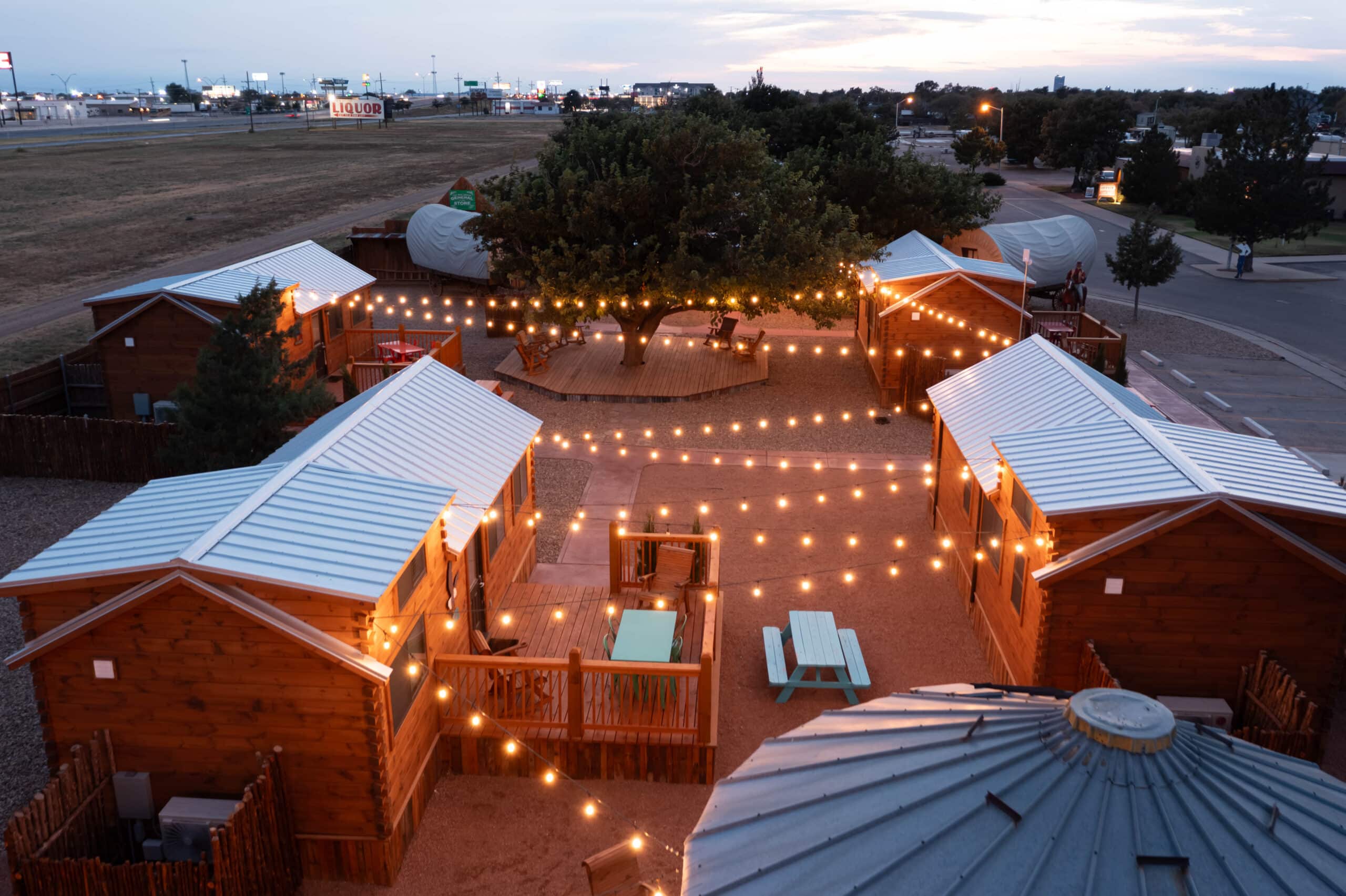 Park Model campsite with lights strung between buildings